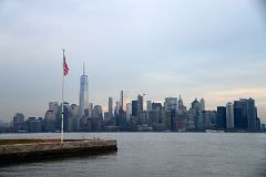 12-20 Hudson River, World Trade Center And Manhattan Financial District And US Flag Leaving Ellis Island.jpg